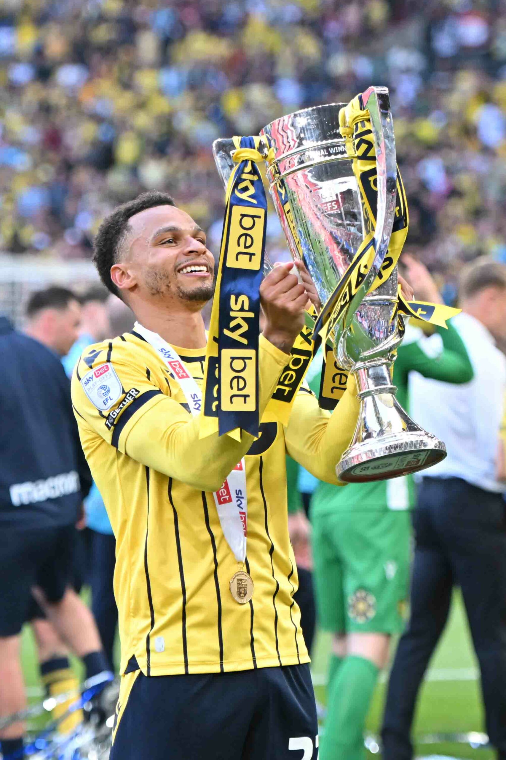 Josh Murphy of Oxford United holds the Sky Bet League 1 Play Off Final trophy designed and made by Thomas Lyte