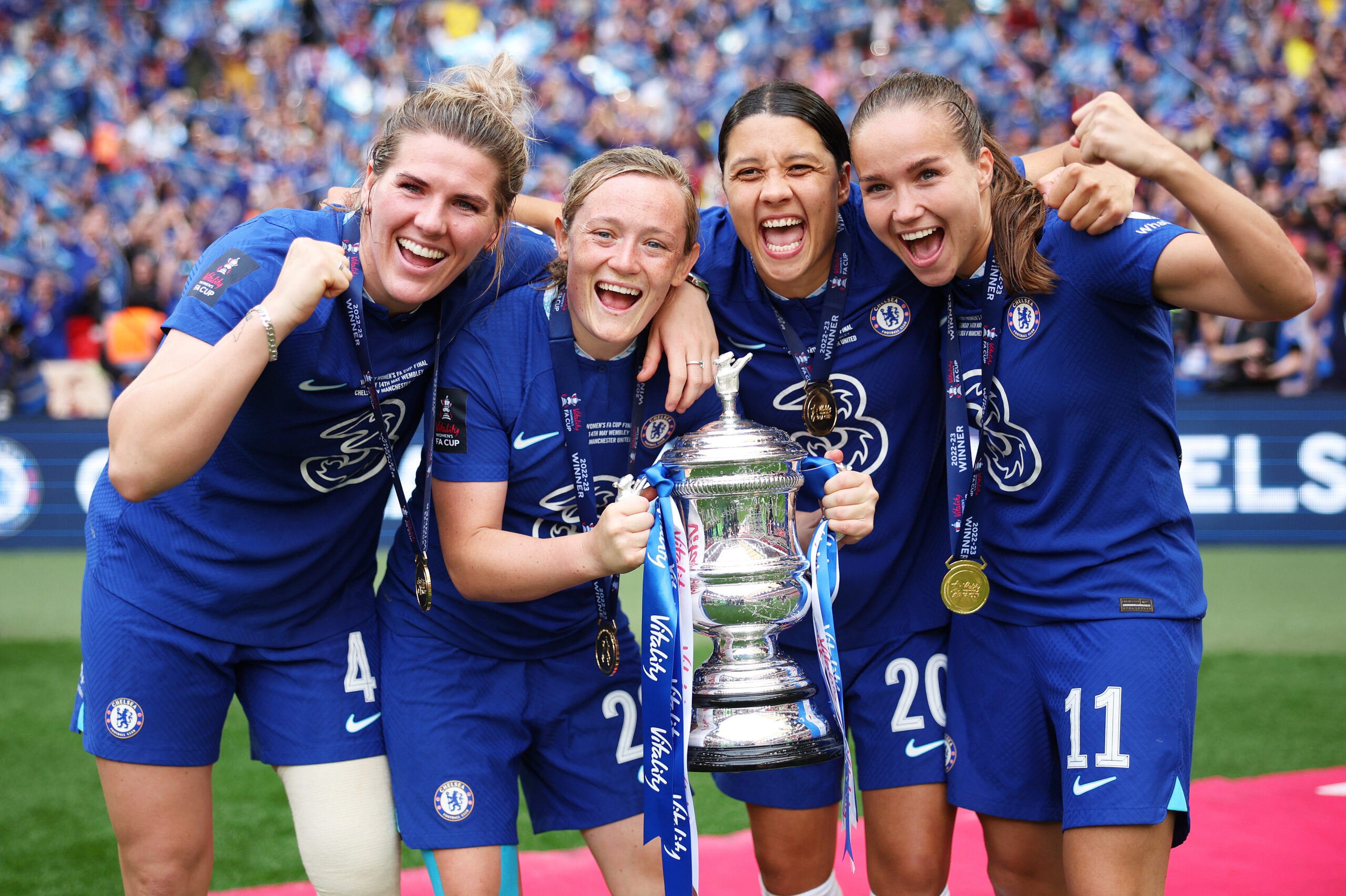 Chelsea players holding the Adobe Women